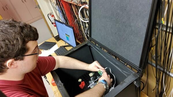 Sean Preins mounting SiPM-on-tile setup for light-yield tests 