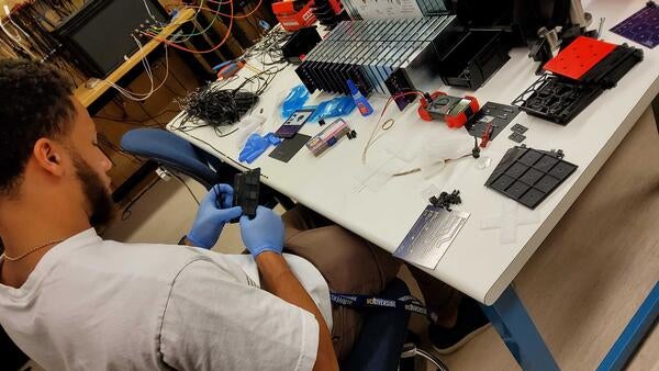 Student building a particle detector