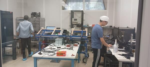 Jiajun Huang and Miguel Rodriguez working on calorimeter insert prototype