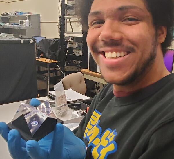 Brice Saunders with scintillator cell for gen-3 prototype