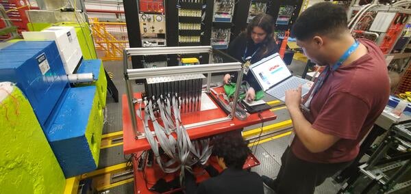 Brice Saunders, Ryan Tsiao and Mia Macias installing detector at Hall-D in Jefferson National Laboratory