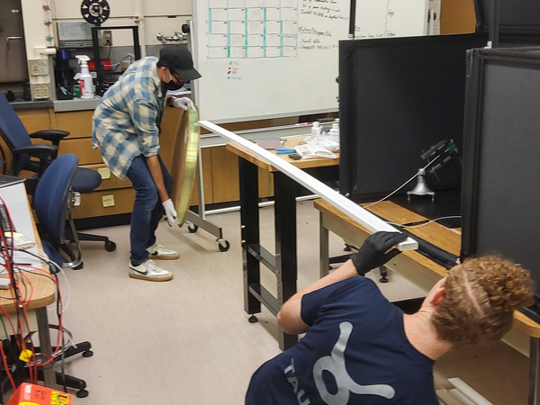 Alec and Miguel R. with a scintillator bar